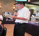 Les Regier making announcements at the dinner.